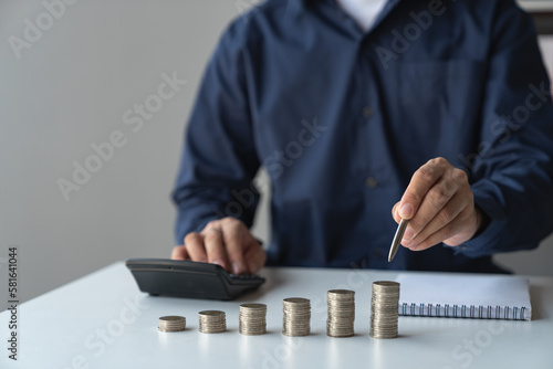 Business accounting for saving money Saving money of modern businessmen, retirees, teenagers Financial concepts on the table For calculations with a calculator to sort coins into a growing graph.