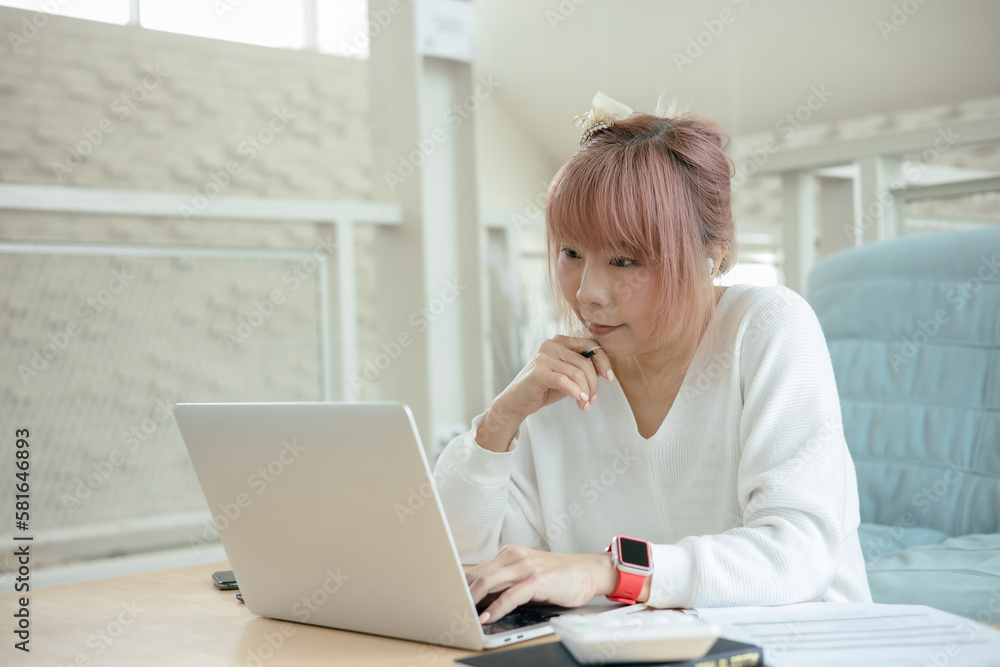 woman using laptop at at living room inside house.