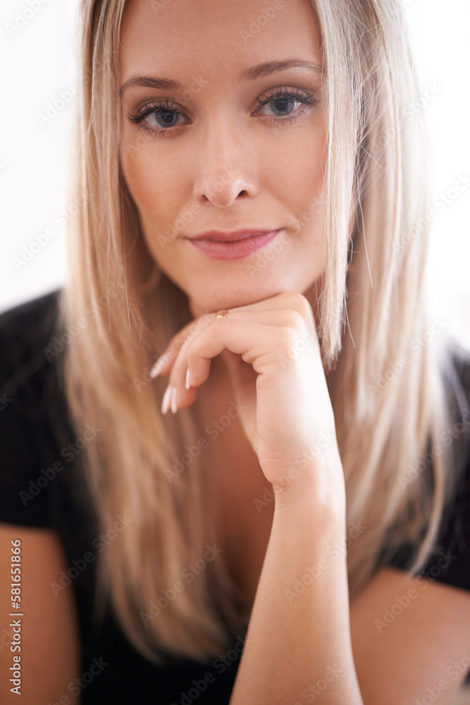 Just a little serious. Portrait of a young woman sitting with her hand on her chin. Just a little serious. Portrait of a young woman sitting with her hand on her chin.