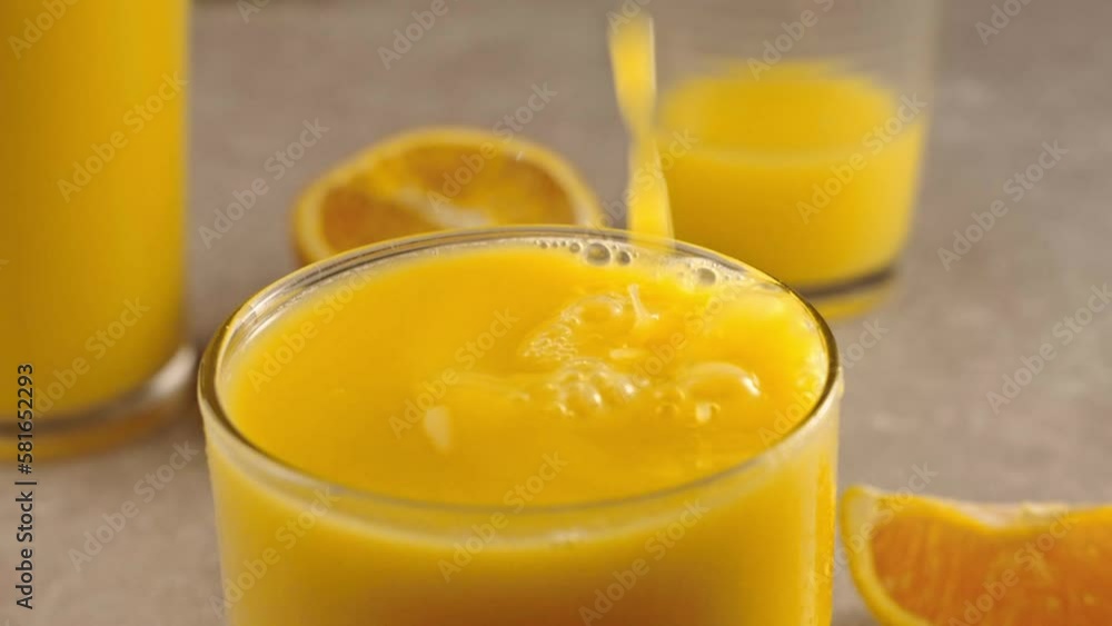 Fresh Orange Juice pouring into a Glass Fresh Orange Juice pouring into a Glass