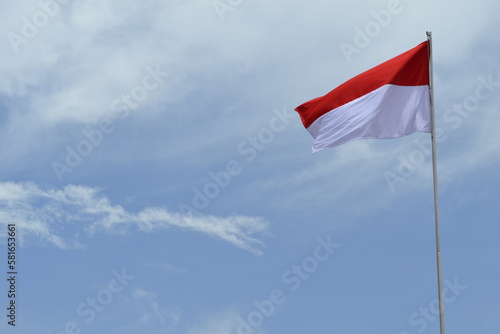 Indonesian flag on the wind with blue sky background