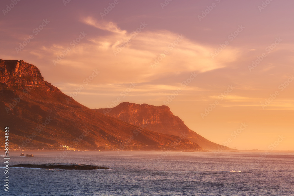 Sunset over the Cape. Scenic view across the water of a mountain at sunset. Sunset over the Cape. Scenic view across the water of a mountain at sunset.