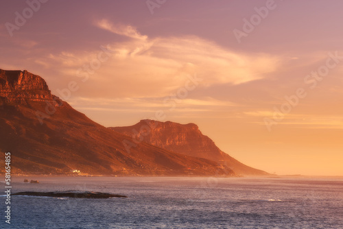 Sunset over the Cape. Scenic view across the water of a mountain at sunset.