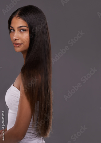 Showing off her luscious locks. Portrait of a beautiful young woman posing in the studio.
