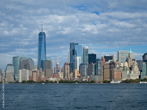 Looking back on Manhattan from the Hudson River and Liberty Island, as the towering high rises of Lower Manhattan loom above the river