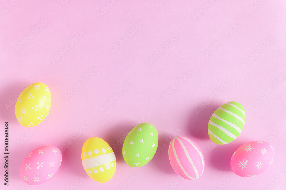Happy Easter holiday greeting card concept. Colorful Easter Eggs and spring flowers on pastel pink background. Flat lay, top view, copy space. Happy Easter holiday greeting card concept. Colorful Easter Eggs and spring flowers on pastel pink background. Flat lay, top view, copy space.