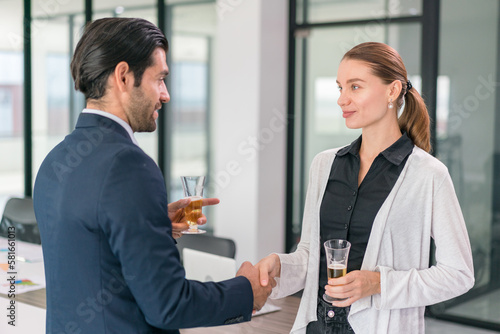 Corporate co-workers having drinks after meeting, People clinking glasses with sparkling wine indoors, Business people celebrating inside modern office.