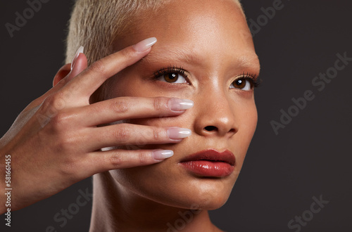 Makeup  beauty and face of woman with manicure in studio for skincare products  cosmetics and wellness. Salon aesthetic  cosmetology and girl model for nails  self love and luxury on dark background