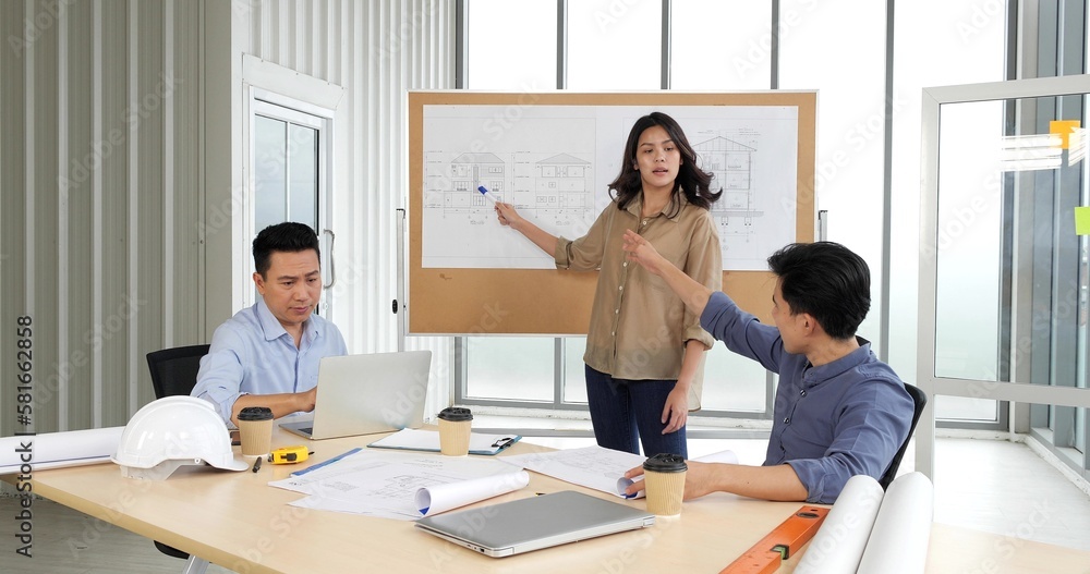 Asian group Architects working on plans with a blueprint at business boardroom table in the Office, Architects discussing business plans Asian group Architects working on plans with a blueprint at business boardroom table in the Office, Architects discussing business plans