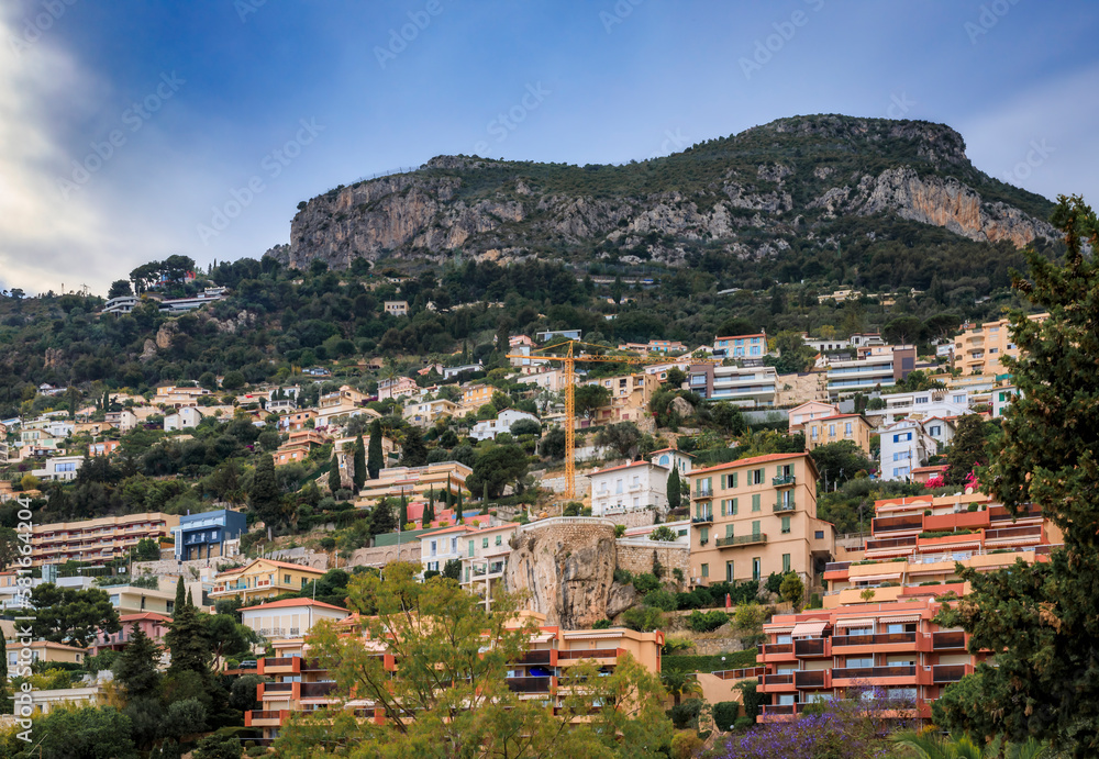View of luxury homes and apartment buildings on a mountain side in Roquebrune Cap Martin, Cote d'Azur or French Riviera, South of France