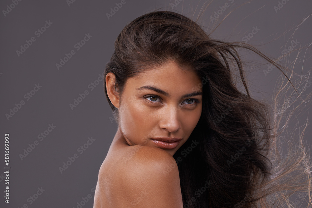 Feeling a little wild. an attractive young woman with windswept hair in studio. Feeling a little wild. an attractive young woman with windswept hair in studio.