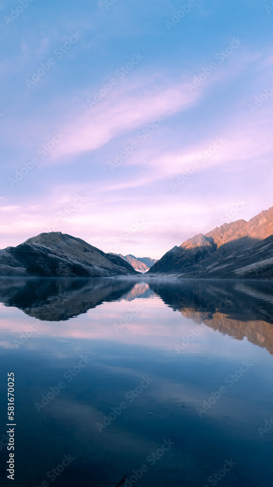 sunrise of lake and mountains in new zealand as vertical wallpaper