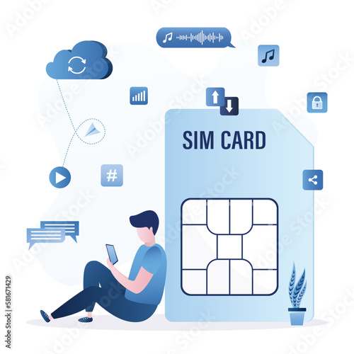 User sits near to large sim card and uses smartphone. Mobile internet, fast wireless connection for calls, communication, video viewing. Wireless communication technology.