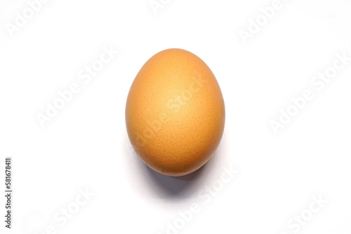 Close up of Brown chicken egg isolated on white background. Flatlay one easter egg. Top view single hen raw egg. Natural nutrition food. Healthy ingredient meal protein product.