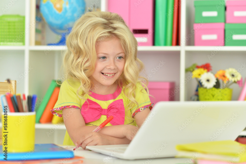 girl using laptop at desk at home girl using laptop at desk at home