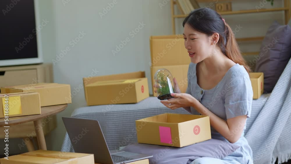Starting small business entrepreneur of independent young Asian woman online seller using a computer showing products to a customer before making a purchase decision. SME delivery concept. Starting small business entrepreneur of independent young Asian woman online seller using a computer showing products to a customer before making a purchase decision. SME delivery concept.