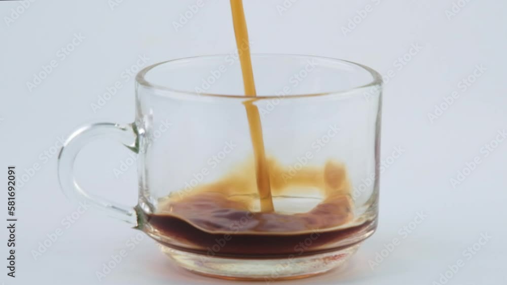 Pouring coffee from moka pot into transparent glass isolated on white background. Close-up of hand pouring freshly brewed drip coffee in a mug. Prepare alternative coffee. Pouring coffee from moka pot into transparent glass isolated on white background. Close-up of hand pouring freshly brewed drip coffee in a mug. Prepare alternative coffee.