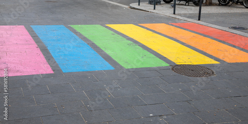 Pedestrian lgbt+ paint town street colours crossing marking in LGBT colourful rainbow lesbian gay flag in city