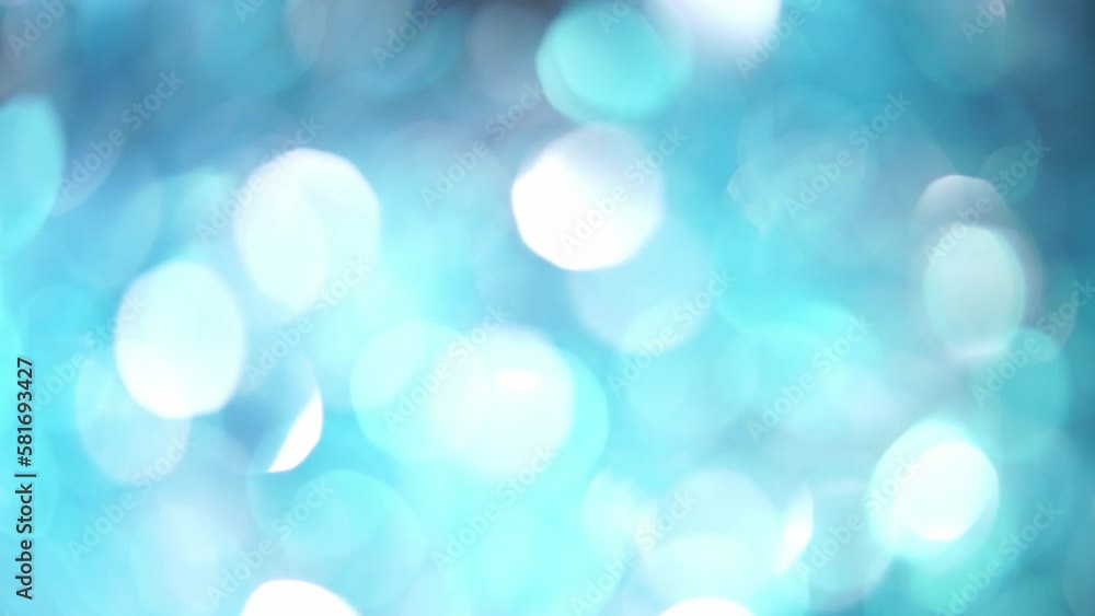 Blinky Backdrop Of Blue And White Bokeh. Abstract movement of light blue defocused circles and light reflexes. Glowing silky bokeh lights motion 4K background. Blinky Backdrop Of Blue And White Bokeh. Abstract movement of light blue defocused circles and light reflexes. Glowing silky bokeh lights motion 4K background.