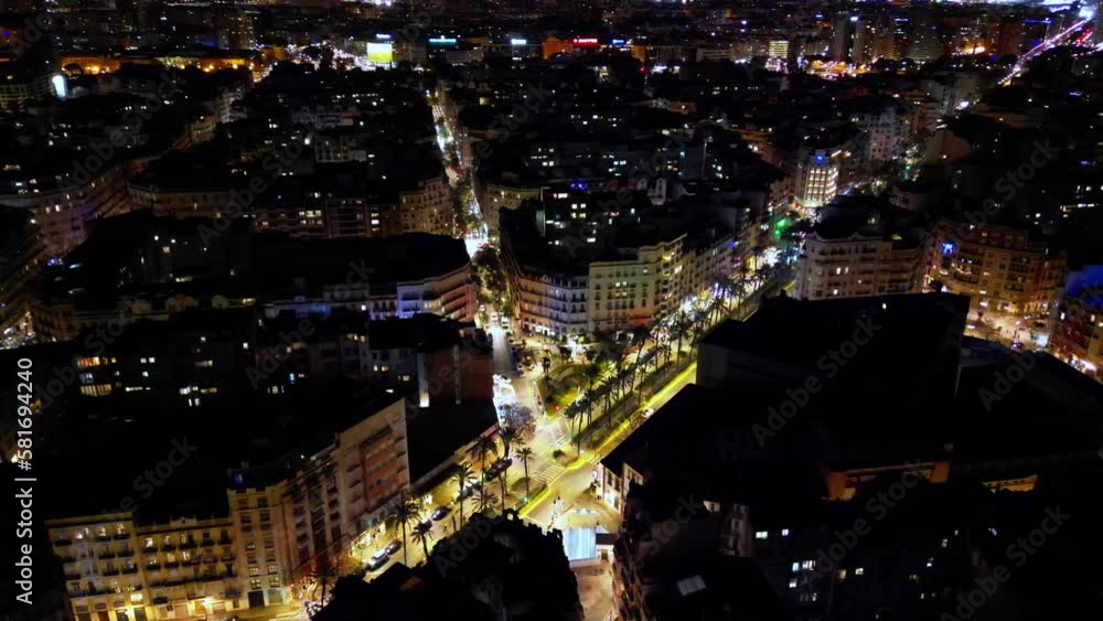 Slow steady shot of downtown valencia's rooftops at night with streets lit up with normal moving traffic , lovely golden shot Slow steady shot of downtown valencia's rooftops at night with streets lit up with normal moving traffic , lovely golden shot