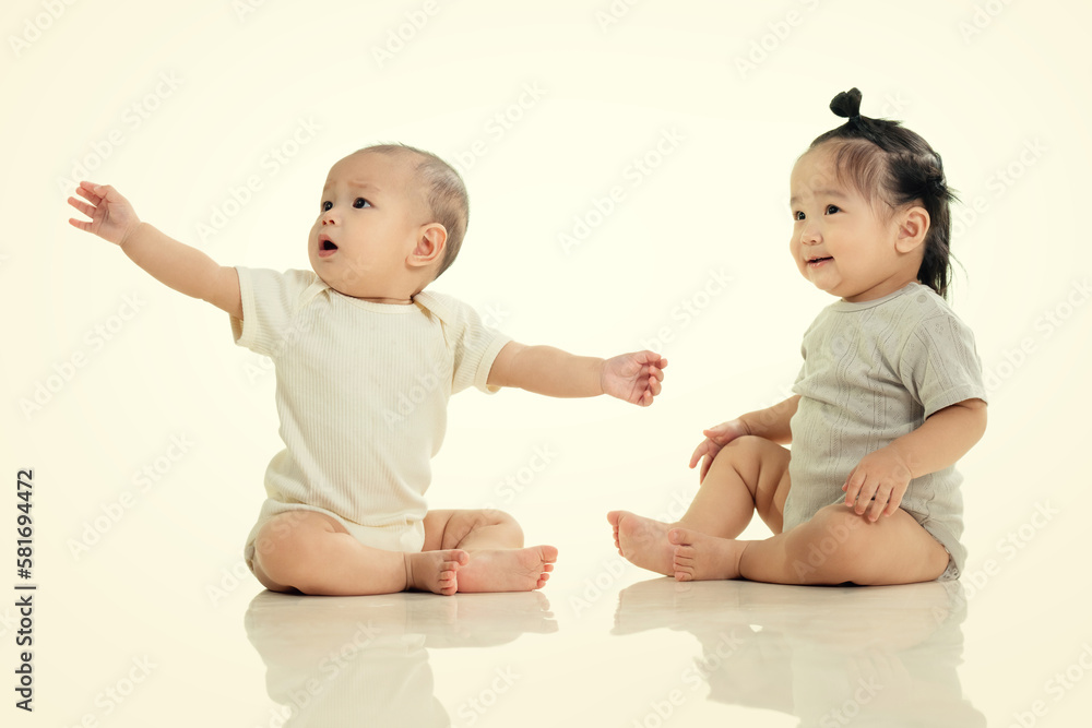 Playing two cute baby sitting on the ground Playing two cute baby sitting on the ground