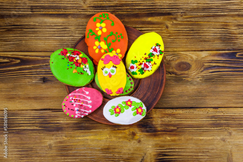 Egg shaped easter gingerbread cookies on wooden table. Top view. Sweets for celebrate Easter