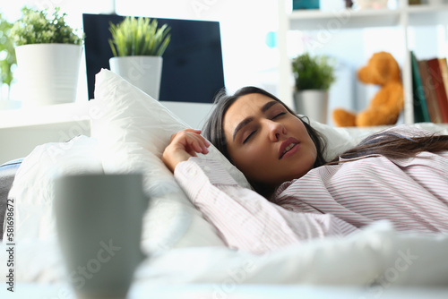 Beautiful young woman sleeping peacefully in bed