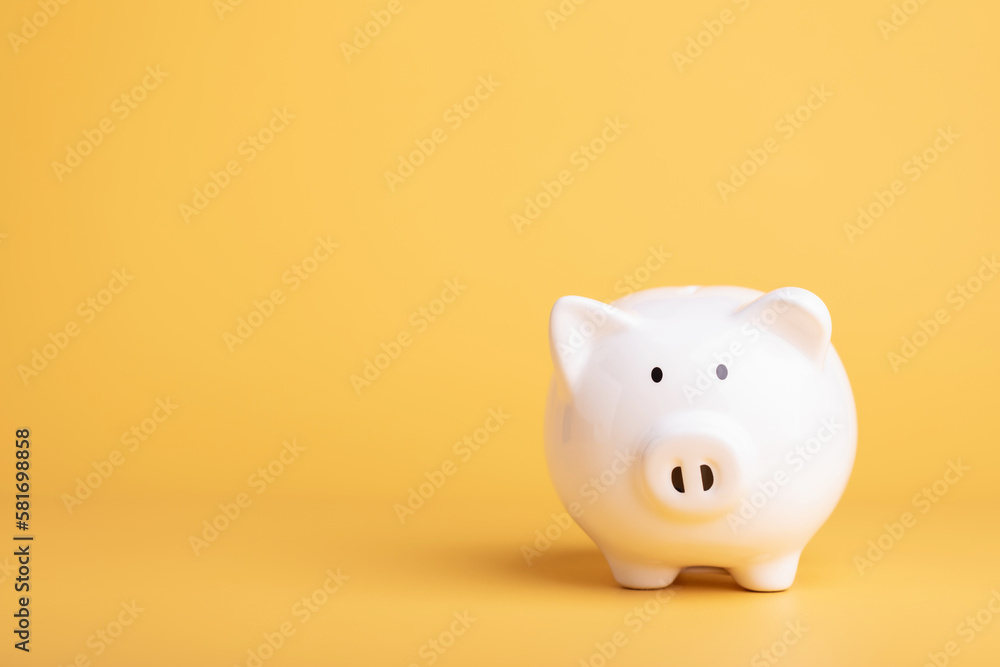 Financial concept, The idea of ​​saving money, Close up white new piggy bank on yellow color copy space. Saving money, Finance or business concept.
