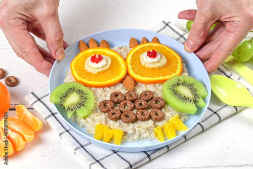 Funny owl oatmeal made of fruits and nuts, food idea for kids. Creative idea for kids breakfast