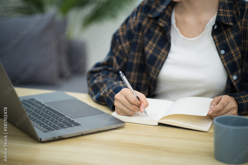 Happy beautiful Asian woman using computer laptop for work online at living room Happy beautiful Asian woman using computer laptop for work online at living room