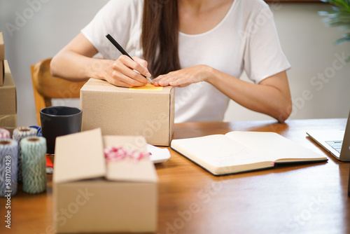 Business From Home Asian woman preparing package delivery box Shipping for shopping online. young start up small business owner at home online order