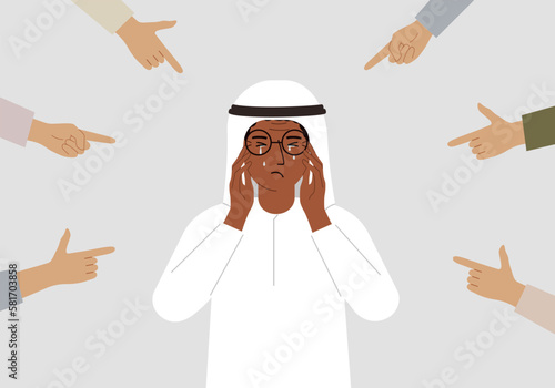 The concept of public condemnation, victim blaming and bullying. Crying depressed man. The fingers point at the character and hate him. Internet cyberbullying.