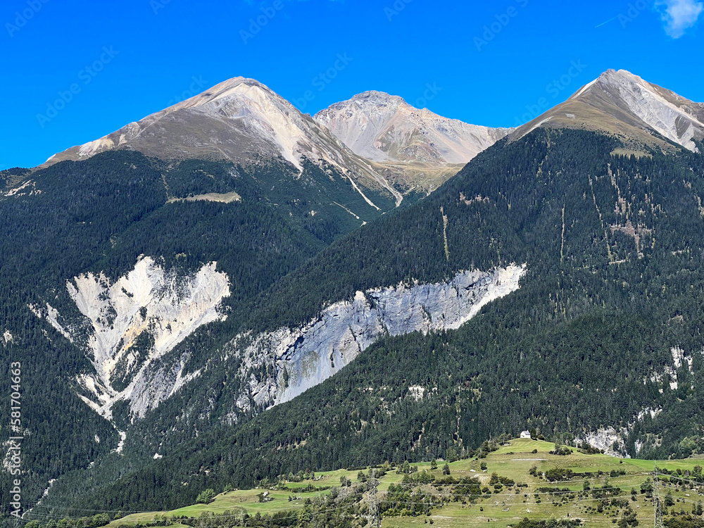 High alpine peaks Piz Linard (2767 m), Lenzerhorn (2906 m) and Piz Mulain (2627 m) above  the river Albula or Alvra - Canton of Grisons, Switzerland (Kanton Graubünden, Schweiz)