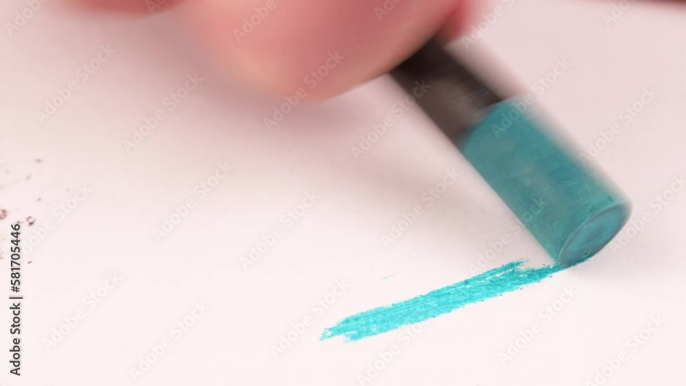 Drawing with a light blue crayon on a piece of paper. Drawing with a light blue crayon on a piece of paper.