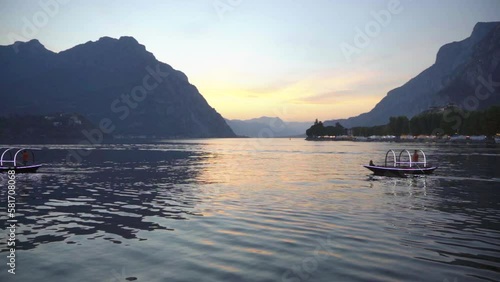 Slow Motion Of Tourist Boats Crossing Lake At Sunset