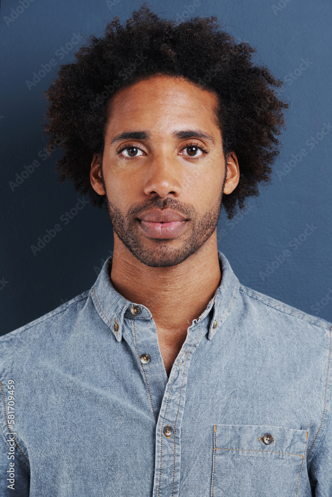 Fototapeta premium Hes a man with a plan in life. Portrait of a confident and handsome young man on a gray background.