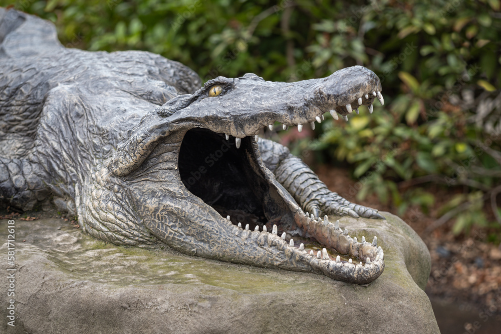 Fototapeta premium Plastic model of a crocodile with an open jaw.