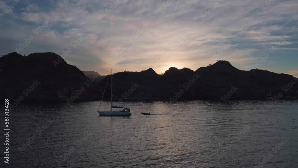 Coastal Landscape, Yacht Sailing Pulling a Dinghy Behind at Sunset in Baja Region Mexico, Mountains in Horizon Coastal Landscape, Yacht Sailing Pulling a Dinghy Behind at Sunset in Baja Region Mexico, Mountains in Horizon
