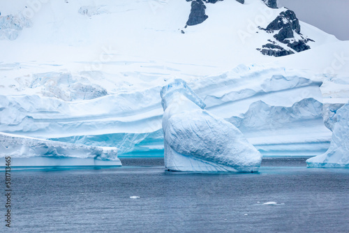 Stark, stunning and each unique, huge icebergs are sculpted by nature and weathered by changing climate as they float slowly through the antarctic oceans.