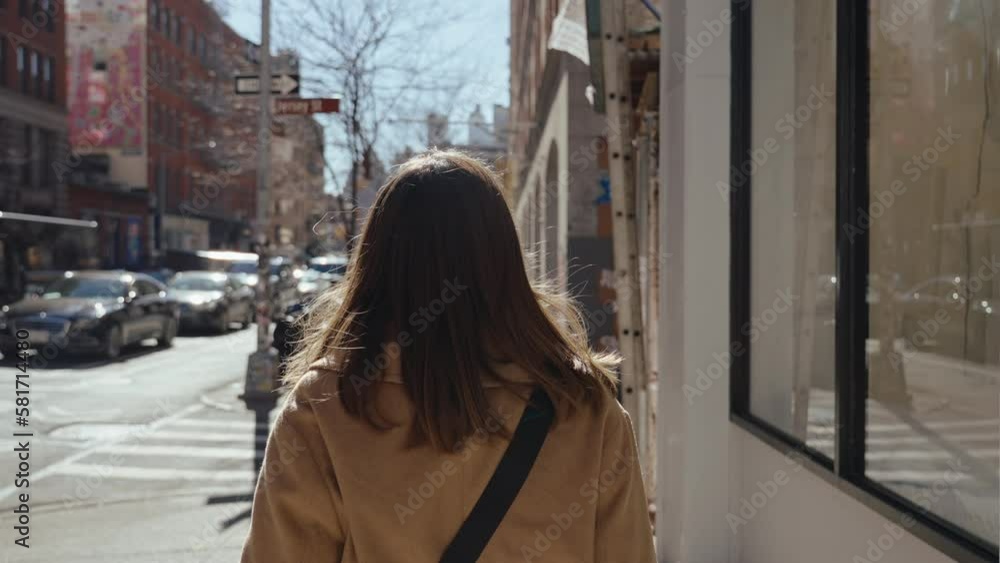 Girl walking on the streets of south Manhattan making a turn New York Girl walking on the streets of south Manhattan making a turn New York