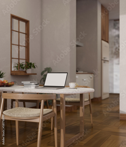 Home workplace, laptop mockup on dining table in beautiful cozy dining room. © bongkarn