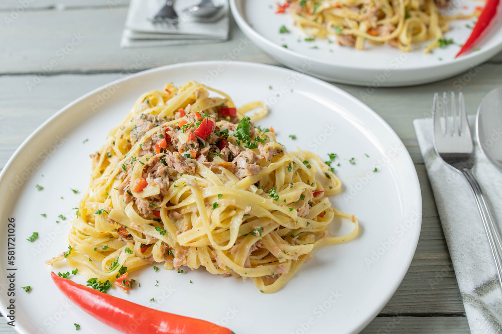 Pasta aglio e olio with tuna. Tagliatelle with olive oil, garlic, parsley and chili. Italian cuisine