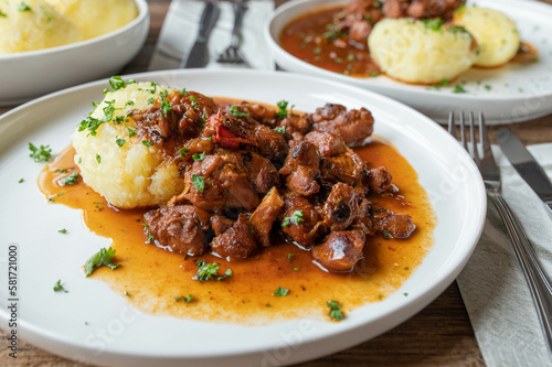Meat dish with potato dumplings on a plate