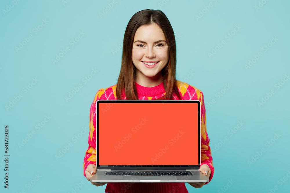 Young smiling fun cheerful student IT woman wear bright casual clothes hold use work on laptop pc computer with blank screen workspace area isolated on plain pastel light blue cyan background studio Young smiling fun cheerful student IT woman wear bright casual clothes hold use work on laptop pc computer with blank screen workspace area isolated on plain pastel light blue cyan background studio