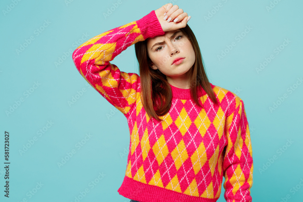 Young sad sick ill tired exhausted dissatisfied caucasian woman wear bright casual clothes put hand on forehead isolated on plain pastel light blue cyan background studio portrait. Lifestyle concept. Young sad sick ill tired exhausted dissatisfied caucasian woman wear bright casual clothes put hand on forehead isolated on plain pastel light blue cyan background studio portrait. Lifestyle concept.