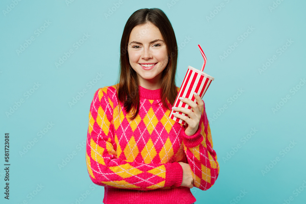 Young smiling cheerful fun woman wearing bright casual clothes hold cup of soda pop cola fizzy water look camera isolated on plain pastel light blue cyan background studio portrait. Lifestyle concept. Young smiling cheerful fun woman wearing bright casual clothes hold cup of soda pop cola fizzy water look camera isolated on plain pastel light blue cyan background studio portrait. Lifestyle concept.