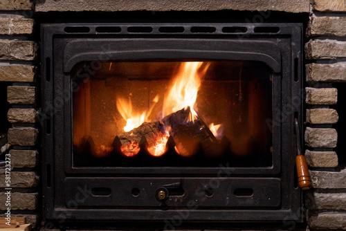 Burning fire in a huge stone fireplace.