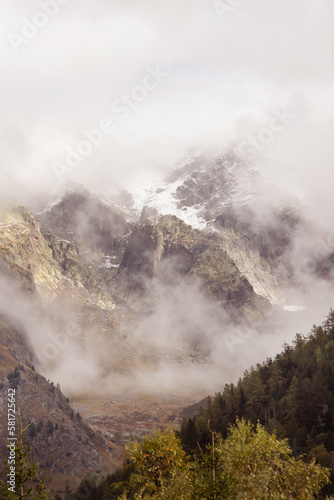 Fantastic snow mountains landscape background with snow peaks and clouds, French Alps, Europe