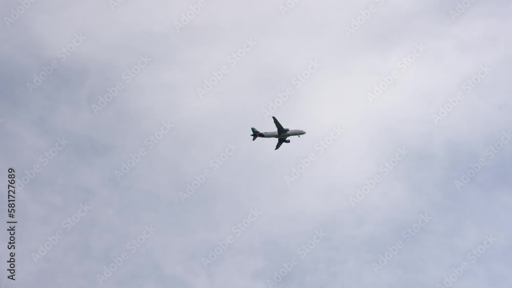 Cologne, Germany - 22 Jun, 2022: Commercial plane on landing, take off against cloudy sky, slow motion Cologne, Germany - 22 Jun, 2022: Commercial plane on landing, take off against cloudy sky, slow motion