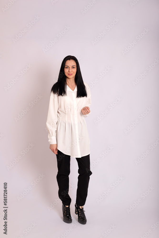 A young female executive in business clothes on a white background A young female executive in business clothes on a white background